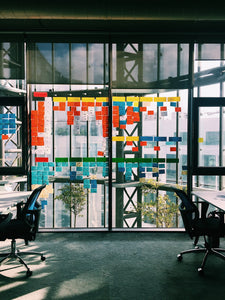 Open work space in a tech company with post it notes on the windows. 